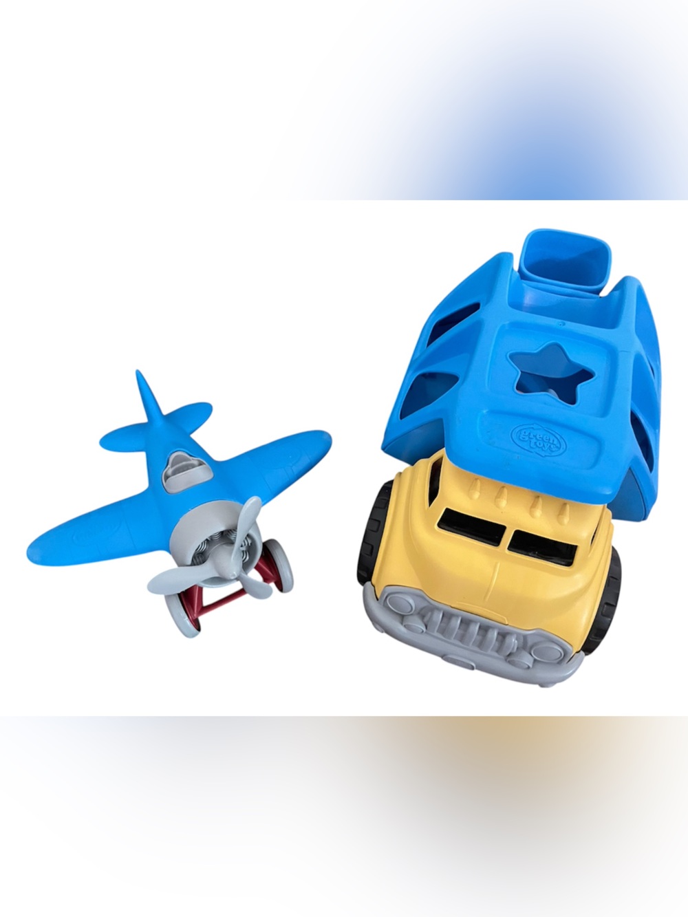 Set of two Green Toys: shape sorter garbage truck and blue airplane